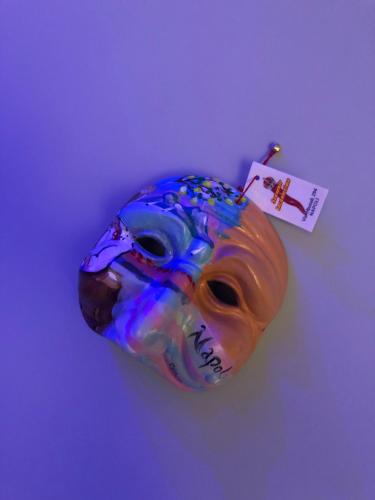a colorful mask sitting on top of a table at Donna Teresa in Naples