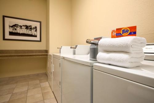 a pile of towels on a counter in a laundry room at Country Inn & Suites by Radisson, Lubbock Southwest, TX in Lubbock