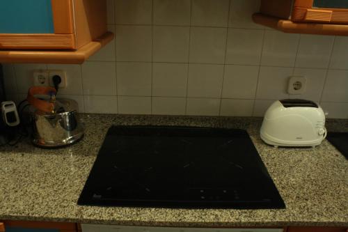 a black tablet on a counter in a kitchen at Candela's Beach Port in Masnou