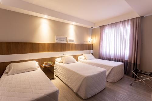 Postel nebo postele na pokoji v ubytování Hotel Melo