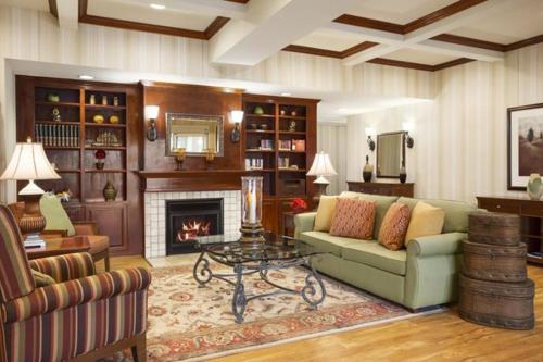 a living room with a couch and a fireplace at Country Inn & Suites by Radisson, Conway, AR in Conway