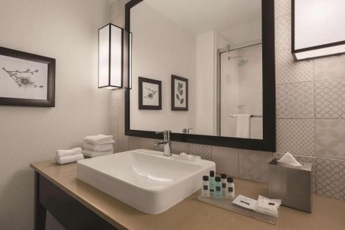 a bathroom with a white sink and a mirror at Country Inn & Suites by Radisson, Lubbock Southwest, TX in Lubbock