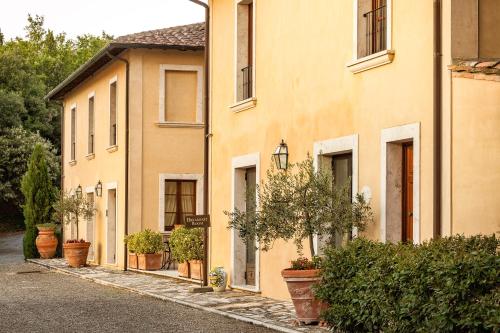 a row of buildings with potted plants on a street at Villa Poggiano in Montepulciano