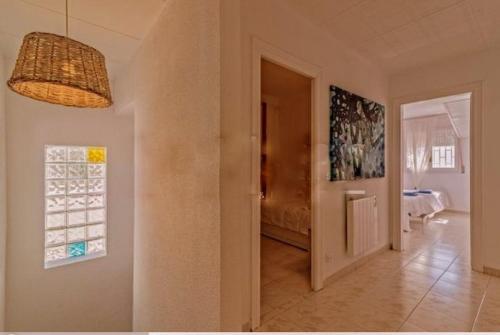 a hallway with a door leading to a dining room at Chalet Santa Susana in Santa Susanna