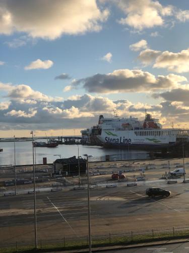 a large cruise ship is parked in a parking lot at Harbour Living by Jutlandia - Hostel Style in Frederikshavn