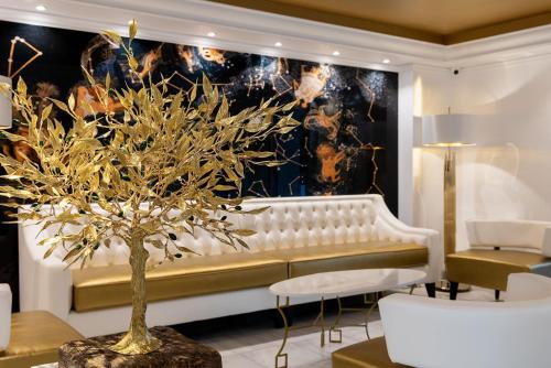 a living room with a white couch and a tree at Hotel Galaxias in Rhodes Town