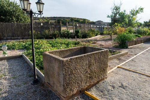 a concrete planter sitting next to a street light at Cal Carreró in Claravalls