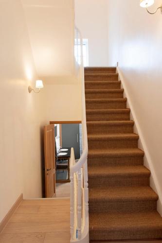 a staircase in a home with a stair case at Plumer House in Ypres