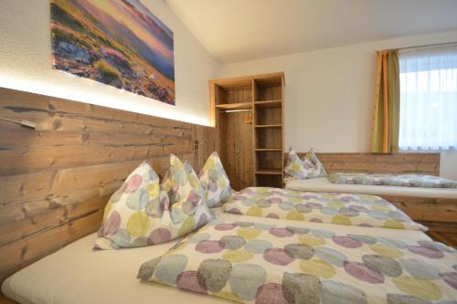 a bedroom with two beds and a painting on the wall at Appartement Jäger Manuela in Flachau