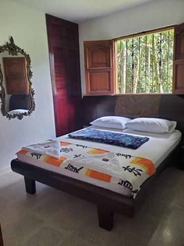 a bed with a comforter with a keyboard on it at Rosita 3 in Jardin