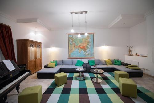 a living room with a blue couch and a piano at Ferienwohnung Mariazell - Hulatsch in Mariazell