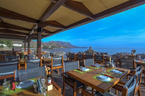 a restaurant with a view of the ocean at Maria Beach Hotel in Kissamos