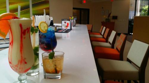 two cocktails sitting on a counter in a restaurant at Holiday Inn Miami West - Airport Area by IHG in Hialeah Gardens