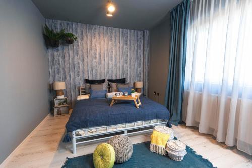 a bedroom with a large bed with a blue comforter at Zorilor View Apartment in Cluj-Napoca