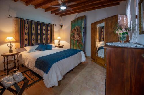 a bedroom with a bed and a dresser in a room at Apanemia Inn House in Lofou