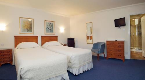 Säng eller sängar i ett rum på The Corbyn Apartments
