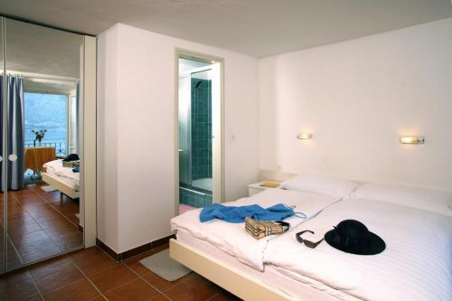 En eller flere senge i et værelse på Hotel Ronco