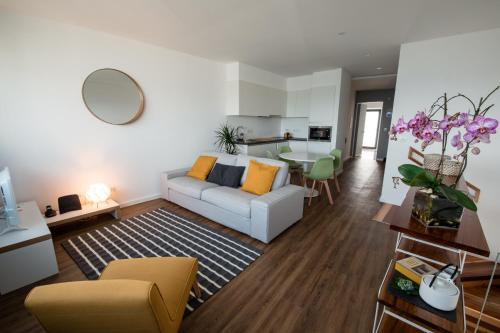 a living room with a couch and a table at Slope House in Lagoa