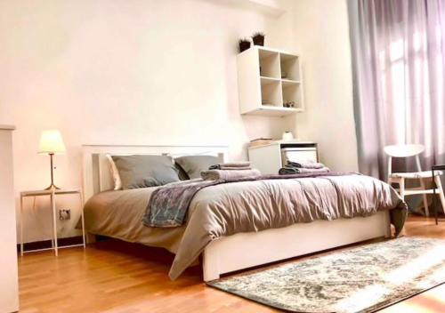 a bedroom with a large bed and a rug at Unique Studios Phaneromenis 41 - Down Town Nicosia in Nicosia