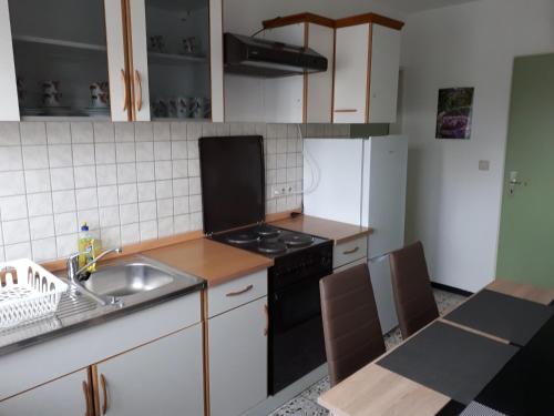 a kitchen with a sink and a stove top oven at Ferienwohnung Brand in Creglingen