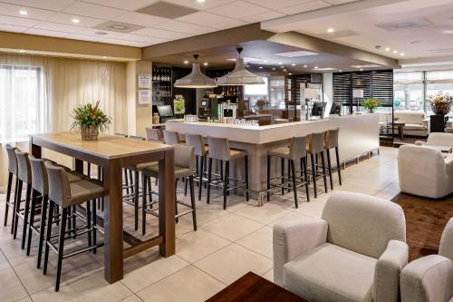 a large lobby with a bar with stools at Holiday Inn Express Amsterdam - South by IHG in Amsterdam