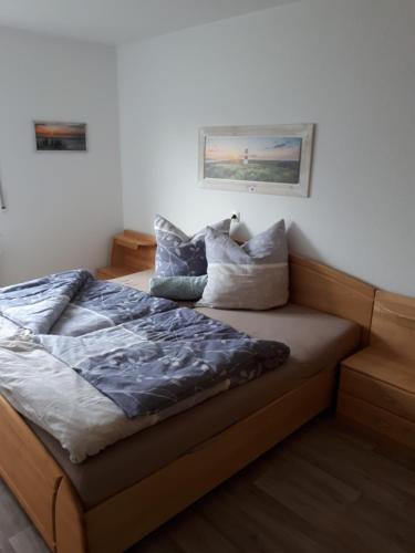 a bed with pillows on it in a bedroom at Ferienwohnung Brand in Creglingen