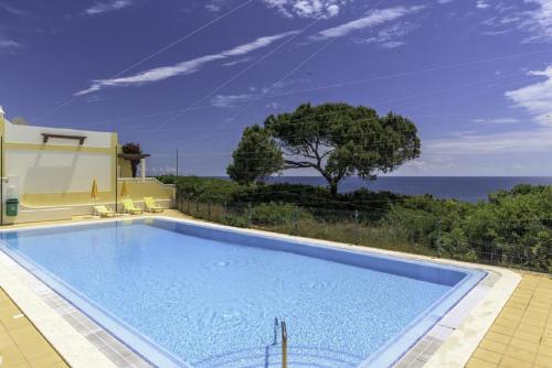 a swimming pool with a view of the ocean at Seaview Terrace Benagil Villa 45 in Benagil