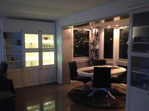 a dining room with a table and some windows at City Marina in Cuxhaven