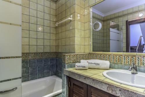 a bathroom with a tub and a sink at Seaview Terrace Benagil Villa 45 in Benagil