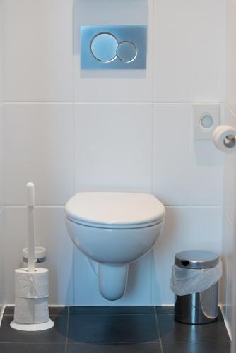 a bathroom with a white toilet in a room at Hôtel de l'Univers Liège in Liège
