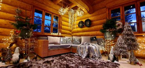 a living room with a couch and christmas decorations at Sunset House in Ulmale