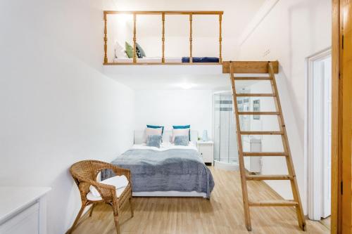 a bedroom with a bed and a ladder at Grand Budapest Apartments in Budapest