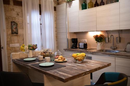 a kitchen with a table with fruit on it at Apanemia Inn Studio in Lofou