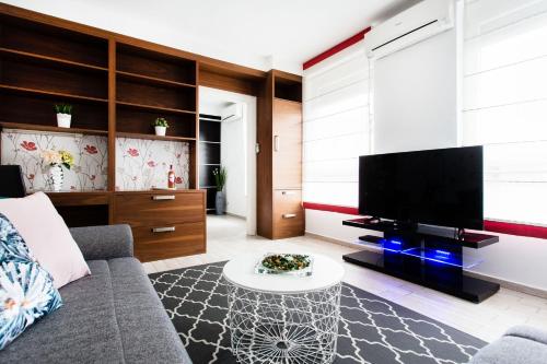 a living room filled with furniture and a tv at Grand Budapest Apartments in Budapest