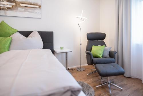 a bedroom with a bed and a chair at MH Living - 11 - Modern Living Dream in Center in Graz