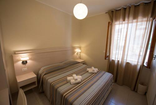 a bedroom with a bed with two towels on it at Donna Rosa Accommodation in Tropea