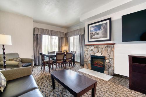 a living room with a couch and a fireplace at Holiday Inn West Yellowstone, an IHG Hotel in West Yellowstone