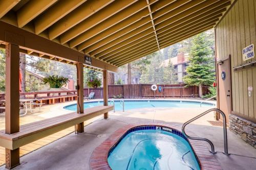 a swimming pool with a hot tub on a patio at Hidden Valley Condominiums in Mammoth Lakes