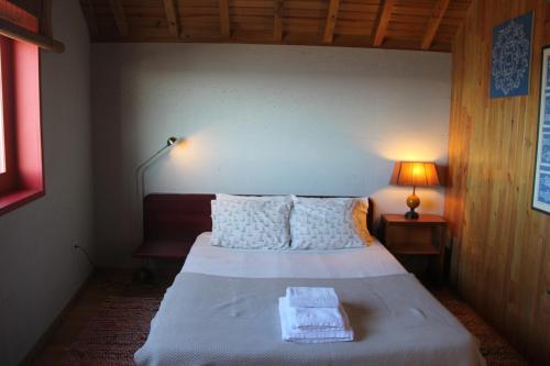 a bedroom with a bed with two towels on it at Casa do Mar in Vila Chã