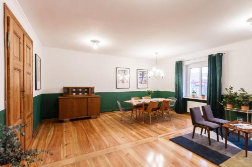 a dining room with a table and chairs at House Apartments Centrum Poznań in Poznań