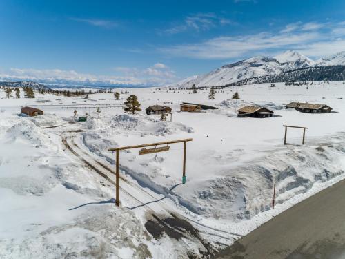 a snow covered field with a basketball hoop at Sierra Meadows Ranch in Mammoth Lakes