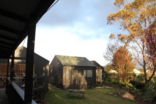 a view from the porch of a house with a bench at Hugo & Carters Backpackers & Motel in Tauranga