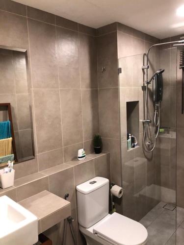 a bathroom with a shower and a toilet and a sink at TimurBay Residence by Onehomes in Kuantan
