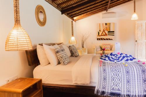 a bedroom with a bed with pillows on it at Puri Samaira in Tanjung