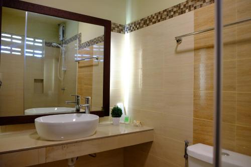 a bathroom with a sink and a mirror at Pacific Waves Inn (Annex) in Baler
