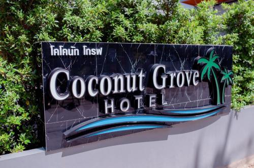 a sign for a coconut grove hotel at Coconut Grove Hotel Samui in Chaweng