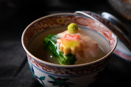 a cup of soup with a piece of food in it at Yufuin Kaze no Mori in Yufuin