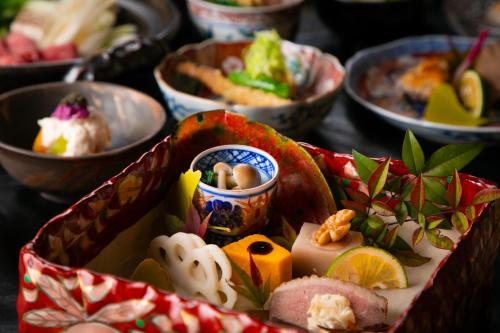 a table with bowls of different types of food at Yufuin Kaze no Mori in Yufuin