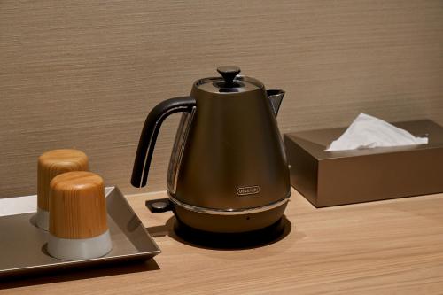 a tea kettle sitting on a counter next to a box at Hotel ZIZI Kyoto Gion in Kyoto