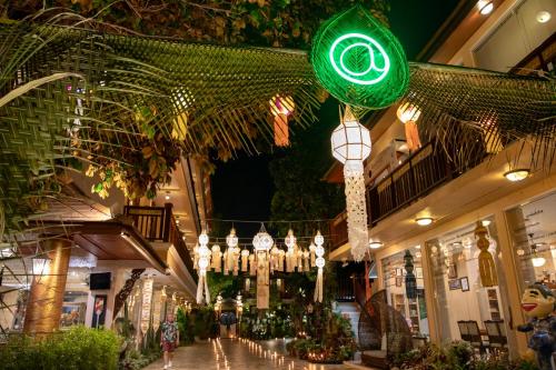 a shopping mall with a green light hanging from the ceiling at At Chiang Mai Hotel in Chiang Mai